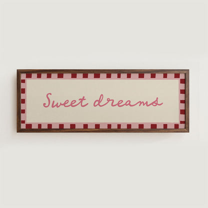Framed sign with 'Sweet dreams' text on a white wall
